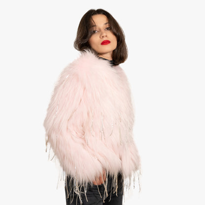 Model wearing a pink fur coat with silver sparkles